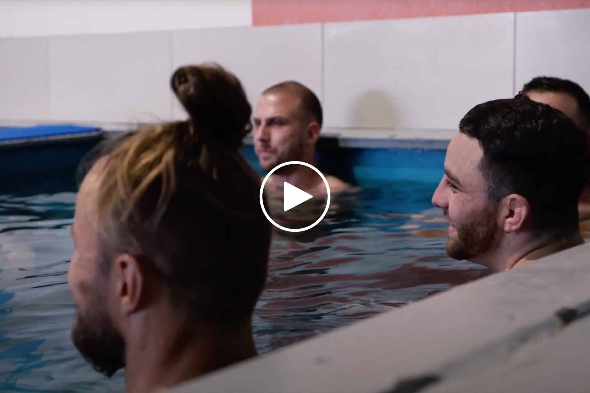 A group of men and women immersed in a P3 Recovery Contrast Therapy pool